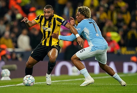 Manchester City's Floyd Samba holds AEK Athens' Harold Moukoudi during the Champions League soccer match between Manchester City and AEK Athens in Manchester, England, Tuesday, Oct. 20, 2026. 