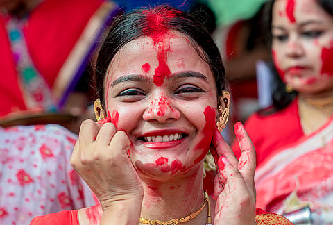 A woman being smeared 'sindoor', vermillion, on her face during 'Sindoor Khela', tradition of playing with vermillion, on 'Vijaya Dashami', last day of Durga Puja festival, at Durgabari Samiti, in Jodhpur, Rajasthan, Tuesday, Oct. 20, 2026. 

