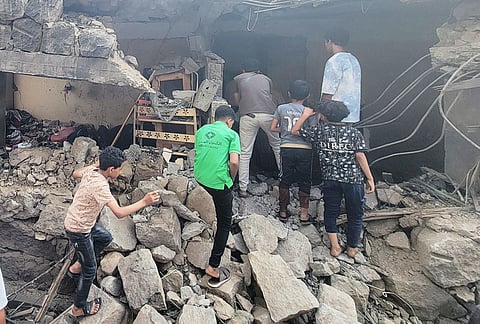 Residents walk amid debris from their homes after a missile strike in Seina, Taiz, Yemen, Tuesday, Oct. 20, 2026. 
