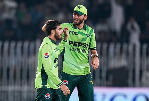 Pakistan's Arafat Minhas, left, celebrates with Shaheen Shah Afridi after taking the wicket of England's Jamie Overton during the tri-series one-day international cricket match between Pakistan and England, in Rawalpindi, Pakistan, Tuesday, Oct. 20, 2026. 