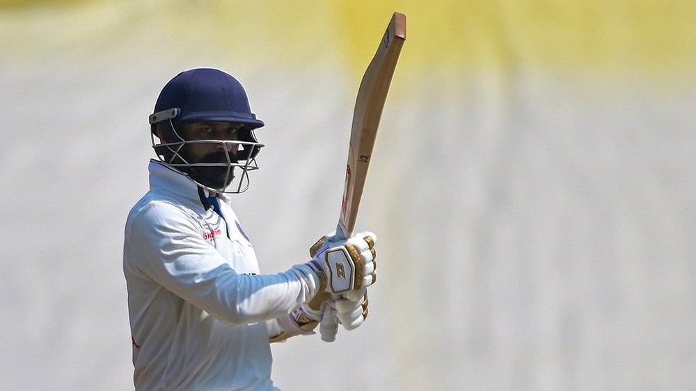 Puducherry's Nikhil Gangta lifts his bat after completing his half-century on the third day of the Ranji Trophy cricket match against Vidarbha at VCA Stadium, in Nagpur, Maharashtra. - | Photo: PTI 