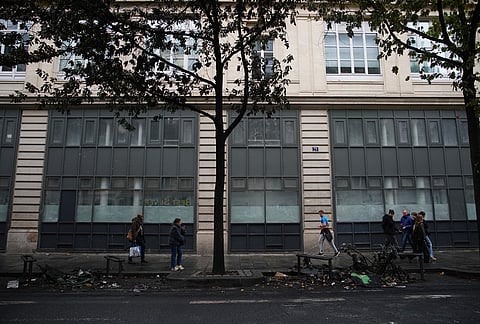 People walk past burned-out bikes after a quiet night Monday under curfew, the first since weekend protests over the cost of living turned into rioting and looting across France, in Paris, Tuesday, Oct. 20, 2026. 
