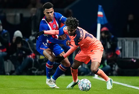 Barcelona's Lamine Yamal, right, is challenged by PSG's Desire Doue during the Champions League opening phase soccer match between Paris Saint-Germain and FC Barcelona in Paris, Tuesday, Oct. 20, 2026. 