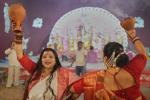 | Photo: AP/Rajesh Kumar Singh : Hindu devotees performs a traditional Dhunuchi dance inside a temporary worship venue of goddess Durga during Durga Puja celebrations on the last day of Durga Puja festival in Prayagraj, in the northern Indian state of Uttar Pradesh, Tuesday, Oct. 20, 2026.