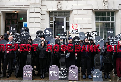 Activists protest against the government's approval of a natural gas project off Scotland's coast at the Department for Energy Security and Net Zero in London, Wednesday, Oct. 21, 2026. 