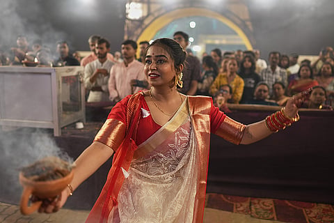 A Hindu devotee performs a traditional Dhunuchi dance inside a temporary worship venue of goddess Durga during Durga Puja celebrations on the last day of Durga Puja festival in Prayagraj, in the northern Indian state of Uttar Pradesh, Tuesday, Oct. 20, 2026.