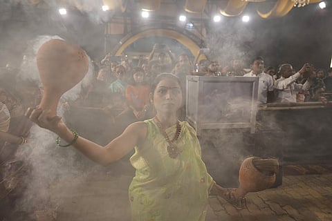 A Hindu devotee performs a traditional Dhunuchi dance inside a temporary worship venue of goddess Durga during Durga Puja celebrations on the last day of Durga Puja festival in Prayagraj, in the northern Indian state of Uttar Pradesh, Tuesday, Oct. 20, 2026.