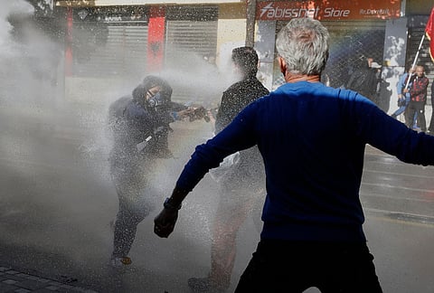 Protesters are sprayed with water during an anti-government protest in Tirana, Albania, Tuesday, Oct. 20, 2026. 