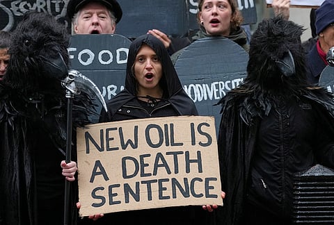 Activists protest against the government's approval of a natural gas project off Scotland's coast at the Department for Energy Security and Net Zero in London, Wednesday, Oct. 21, 2026. 
