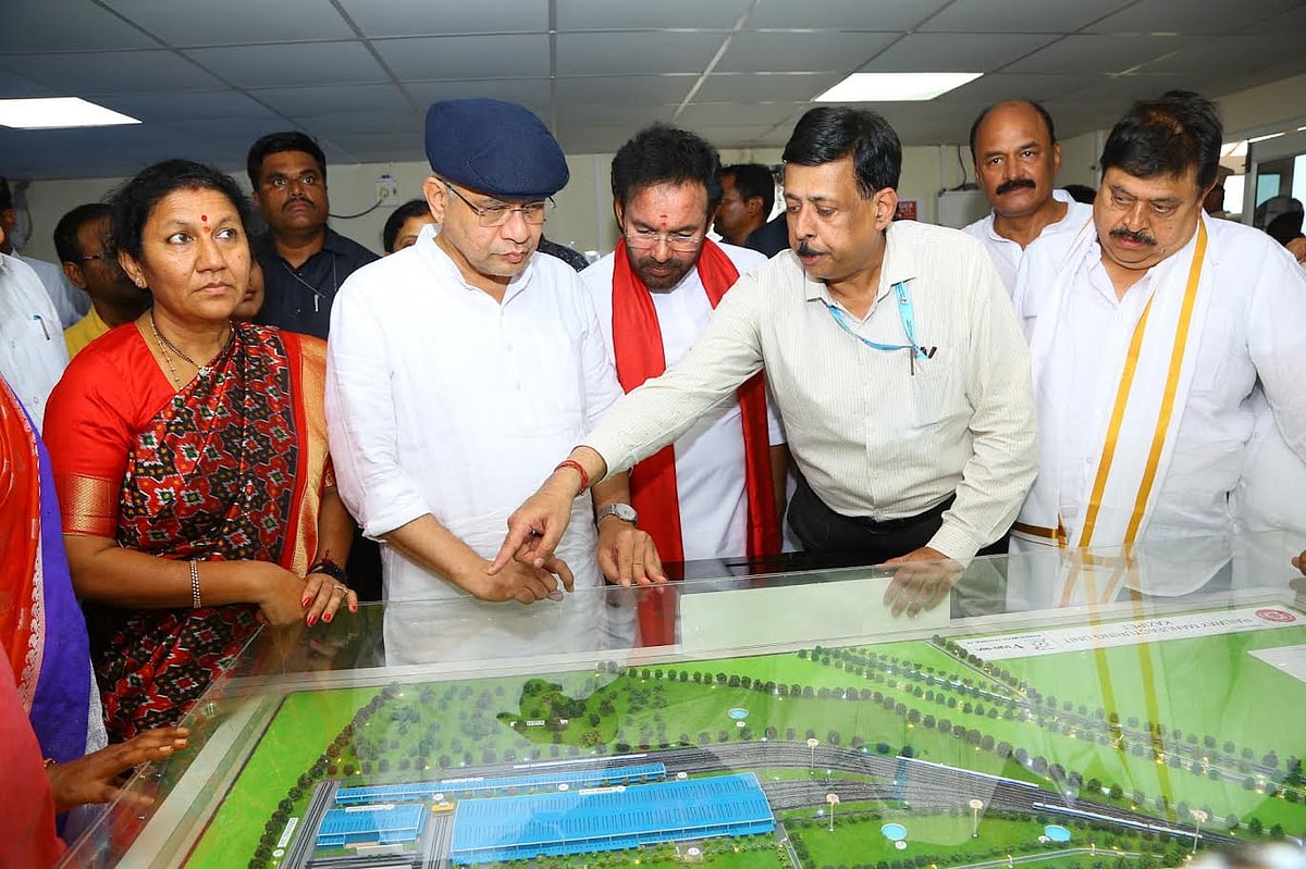 Railway minister checking a project model