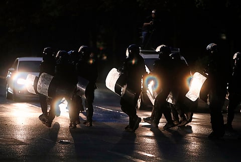 Riot police with shields cross a road during an anti-government protest in Tirana, Albania, Tuesday, Oct. 20, 2026. 