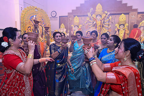 Women perform ‘dhunuchi’ dance during the ‘Durga Puja’ festival, in Jaipur, Monday, Oct. 19, 2026.