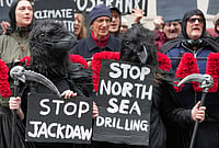 | Photo: AP/Kirsty Wigglesworth : Activists protest against the government's approval of a natural gas project off Scotland's coast at the Department for Energy Security and Net Zero in London, Wednesday, Oct. 21, 2026. 
