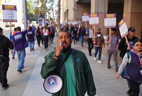 Arturo Meneses leads a chant in support of SEIU Local 1000 state workers during a one-day strike on Wednesday, Oct. 21, 2026, in Los Angeles. 
