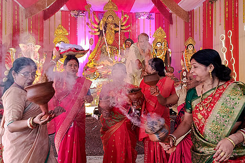 Women perform 'Dhunuchi' dance during the ninth day of the Durga Puja festival, at a pandal, in Bastar district, Chhattisgarh, Tuesday, Oct. 20, 2026.