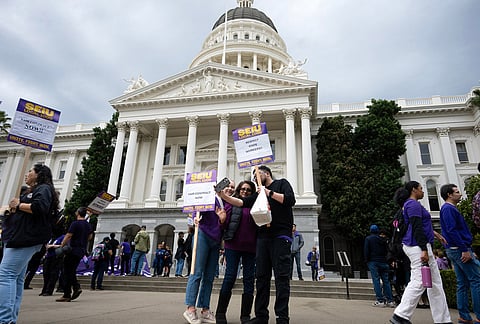 Members of SEIU Local 1000 gather in front of the state capitol during a one-day strike on Wednesday, Oct. 21, 2026, in Sacramento, California. 