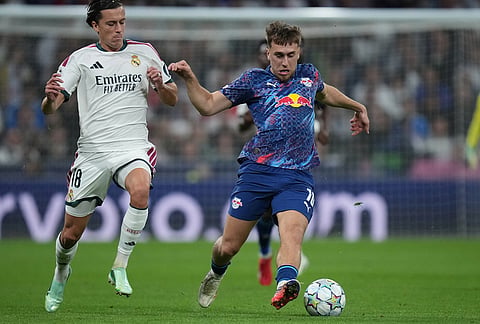 Leipzig's Brajan Gruda, right, challenges for the ball with Real Madrid's Alvaro Carreras during the Champions League opening phase soccer match between Real Madrid and Leipzig in Madrid, Wednesday, Oct. 21, 2026. 