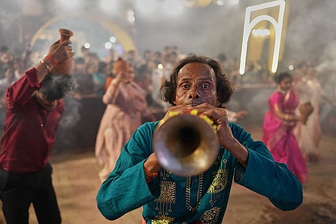 Hindu devotees performs a traditional Dhunuchi dance inside a temporary worship venue of goddess Durga during Durga Puja celebrations on the last day of Durga Puja festival in Prayagraj, in the northern Indian state of Uttar Pradesh, Tuesday, Oct. 20, 2026.