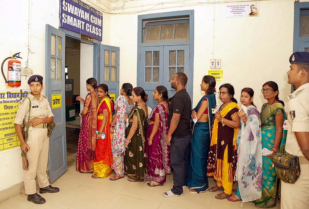 Voters wait in a queue at a polling station as they arrive to cast their vote for the Graduate and Patna Teacher constituencies of the Bihar Legislative Council (MLC), in Patna. - | Photo: PTI 
