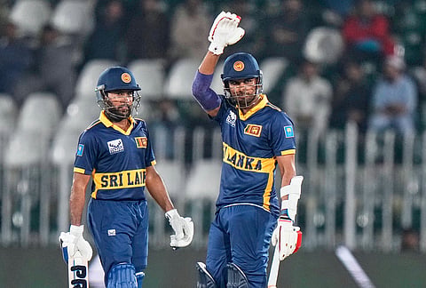 Sri Lanka's Dasun Shanaka, right, celebrates after scoring fifty runs as Pavan Rathnayake watches during the tri-series one-day international cricket match between Sri Lanka and England, in Rawalpindi, Pakistan, Thursday, Oct. 22, 2026. 
