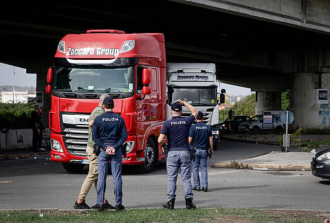 Police stand by as truck drivers gather to protest rising fuel prices in Naples, Italy, Thursday Oct. 22, 2026. 
