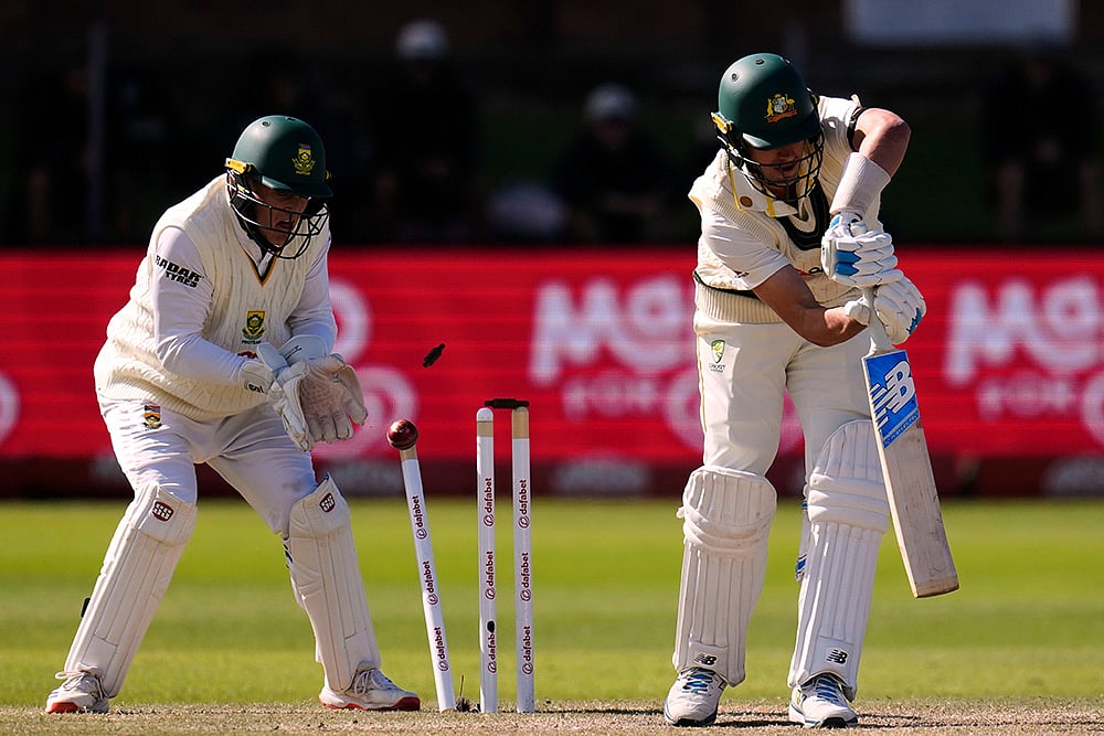 Australias captain Pat Cummins, right, is bowled as South Africas Ryan Rickelton plays behind the wicket on day five of the second cricket test match between South Africa and Australia, in Gqeberha, South Africa, Thursday, Oct. 22, 2026.