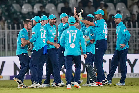 England's Liam Dawson, left, and teammates celebrates after the dismissal of Sri Lanka's Dasun Shanaka during the tri-series one-day international cricket match between Sri Lanka and England, in Rawalpindi, Pakistan, Thursday, Oct. 22, 2026. 