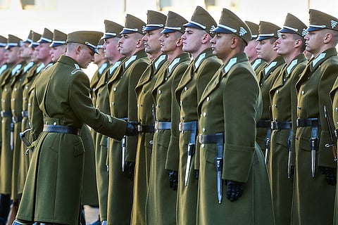 Honor guards get their outfits checked before a flag-raising ceremony marking the 70th anniversary of the 1956 Hungarian Revolution against Soviet-backed communist rule in Budapest, Hungary, Friday, Oct. 23, 2026.