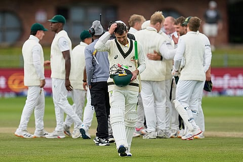 Australia's Alex Carey, center, walks off the field as South African players celebrate winning the second cricket test match between South Africa and Australia on day five, in Gqeberha, South Africa, Thursday, Oct. 22, 2026. 
