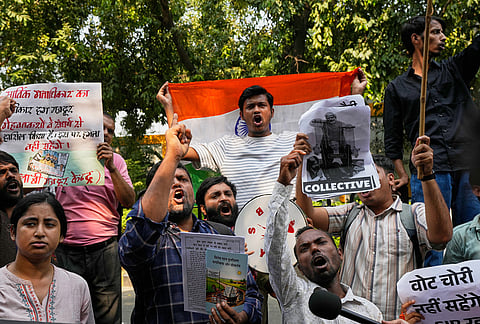People carrying Indian flags in New Delhi, protest against the revision of electoral rolls that removed more than 130 million voters from the lists, Friday, Oct. 23, 2026. 
