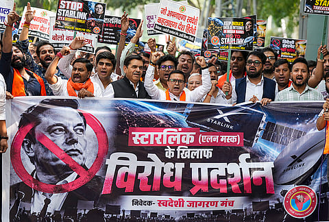 Swadeshi Jagran Manch (SJM) members hold a banner and placards during a protest march against Starlink, the satellite-based internet service owned by industrialist Elon Musk, in New Delhi, Friday, Oct. 23, 2026. 
