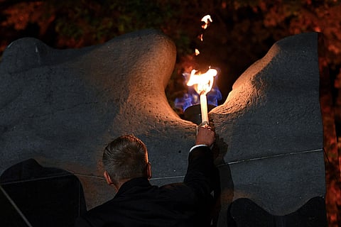 Hungarian Prime Minister Peter Magyar lights the flame of revolution during the commemoration of the 70th anniversary of the outbreak of the Hungarian Revolution and Freedom Fight of 1956 against Soviet oppression, Thursday, Oct. 22, 2026, at Nagy Imre Square in Budapest, Hungary.