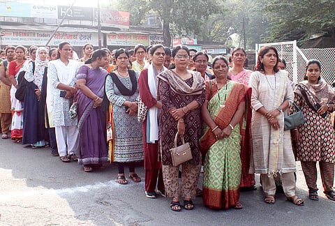 Voters wait in queues outside a polling station as they arrive to cast their votes for the Maharashtra Legislative Council's Pune Division Graduates' and Teachers' constituencies, in Solapur.