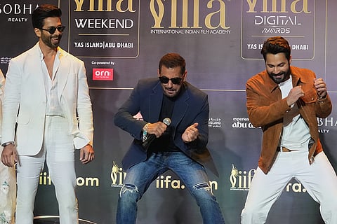 Bollywood actor Shahid Kapoor, left, looks on as actors Salman Khan, center, and Varun Dhawan perform dance moves during a press conference to announce the dates and venue for the 2027 International Indian Film Academy (IIFA) Awards in Mumbai, India, Thursday, Oct. 22, 2026.