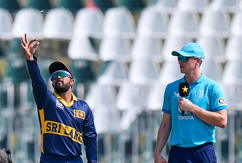 Sri Lanka's captain Kusal Mendis tosses the coin as England captain Harry Brook watches before start of the tri-series one-day international cricket match between Sri Lanka and England, in Rawalpindi, Pakistan, Thursday, Oct. 22, 2026. 