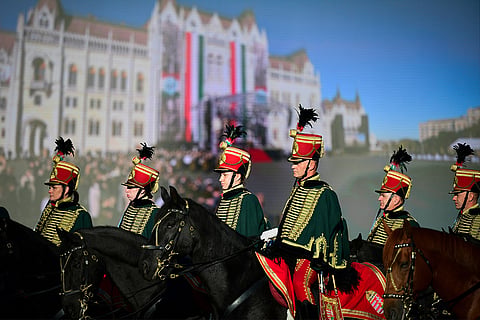 Honor guards attend a flag-raising ceremony marking the 70th anniversary of the 1956 Hungarian Revolution against Soviet-backed communist rule in Budapest, Hungary, Friday, Oct. 23, 2026.
