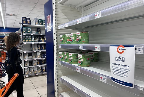 A notice on empty shelves at a supermarket apologizes to customers for the lack of products, due to an ongoing truckers strike in Naples, Italy, Tuesday, Oct. 20, 2026. 
