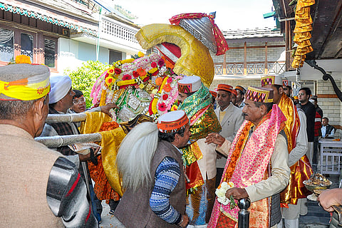Devotees take part in a religious procession of Lord Raghunath during the ‘Kullu Dussehra’ festival, Wednesday, Oct. 21, 2026.