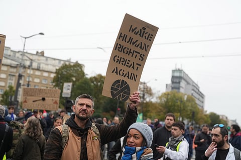 Protesters attends a demonstration against rising living costs in Paris, Saturday, Oct. 24, 2026.