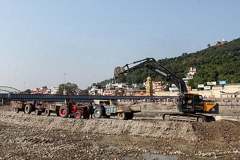 An earthmover clears the debris at the site following the temporary closure of Ganga canal for annual maintenance and repair work, at Har Ki Pauri, in Haridwar, Uttarakhand.