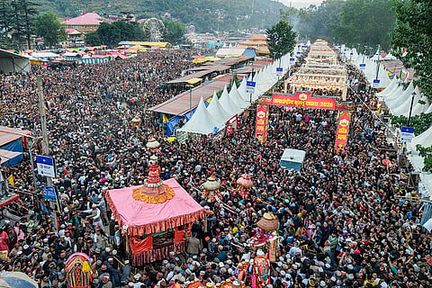 Devotees take part in a religious procession of Lord Raghunath during the ‘Kullu Dussehra’ festival, Wednesday, Oct. 21, 2026.