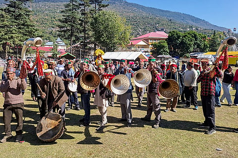 Local musicians play traditional instruments as palanquins carrying village deities arrive at Dhalpur ground ahead of the seven-day Kullu Dussehra festival, in Kullu, Himachal Pradesh, Monday, Oct. 19, 2026.