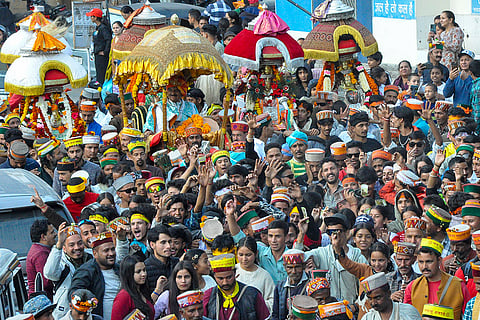 Devotees carrying palanquins of local deities take part in the traditional procession of Lord Narasimha during the ongoing week-long International Kullu Dussehra festival, in Kullu, Friday, Oct. 23, 2026.