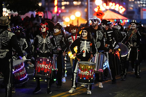 Brazilian drum and dance group VamoLá performs in a parade during a Día de Muertos celebration at Pike Place Market, Friday, Oct. 23, 2026, in Seattle.