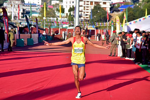 An army official celebrates after winning the men's 5-km race during the fourth edition of Tawang Marathon, at Gyalwa Tsangyang Gyatso High Altitude Stadium, in Tawang district, Arunachal Pradesh.