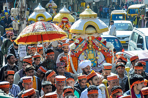 Devotees take part in a religious procession of Lord Raghunath during the ‘Kullu Dussehra’ festival, Wednesday, Oct. 21, 2026.