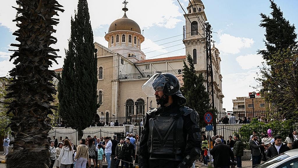 Security personnel stand outside Saint George's Greek Orthodox Church in Hamoud village, Karak, on October 24, a day after the fatal shooting. -  | Reuters