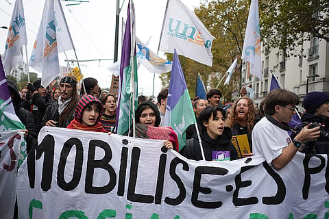 Students behind a banner reading in French "mobilized" march during a demonstration against rising living costs in Paris, Saturday, Oct. 24, 2026.