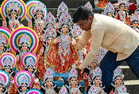 A vendor arranges idols of Goddess Lakshmi for sale ahead of Lakshmi Puja, in Nadia district, West Bengal, Saturday, Oct. 24, 2026. 
