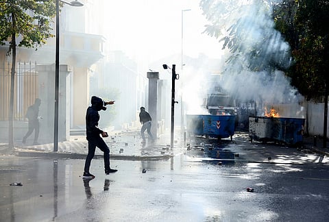 Protesters throw rocks at police during an anti-government rally, in Tirana, Albania, Saturday, Oct. 24, 2026. 
